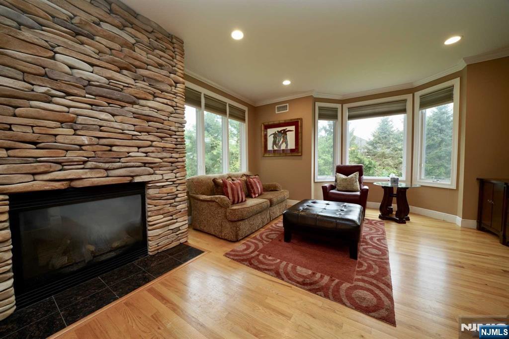 1 Candlewood Drive, Unit 1 Old Tappan, NJ 07675 - Photo 12 of 27 a living room with furniture flat screen tv and a fireplace