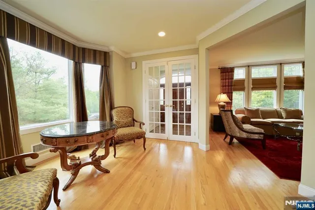 a living room with furniture and large windows