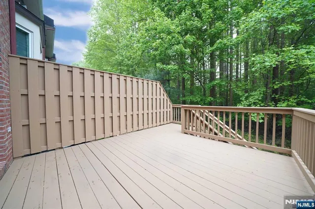 a balcony with wooden floor and fence