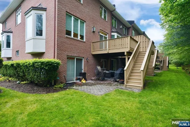 a view of a house with a yard and stairs