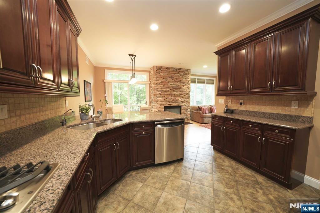 1 Candlewood Drive, Unit 1 Old Tappan, NJ 07675 - Photo 9 of 27 a large kitchen with granite countertop a stove a sink and a microwave