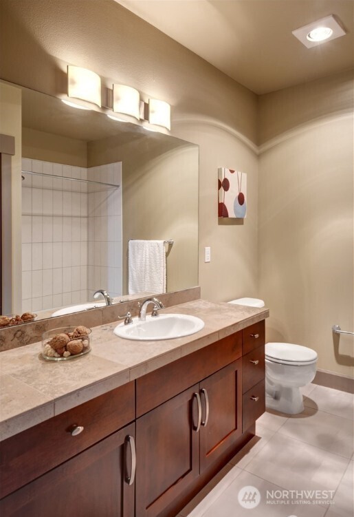 1840 25th Avenue Northeast, Unit 405 Issaquah, WA 98029 - Photo 12 of 20 a bathroom with a granite countertop toilet sink and mirror