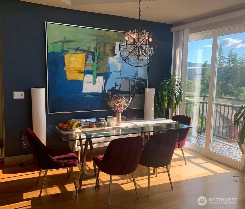 1840 25th Avenue Northeast, Unit 405 Issaquah, WA 98029 - Photo 6 of 20 a view of a dining room with furniture a chandelier and wooden floor