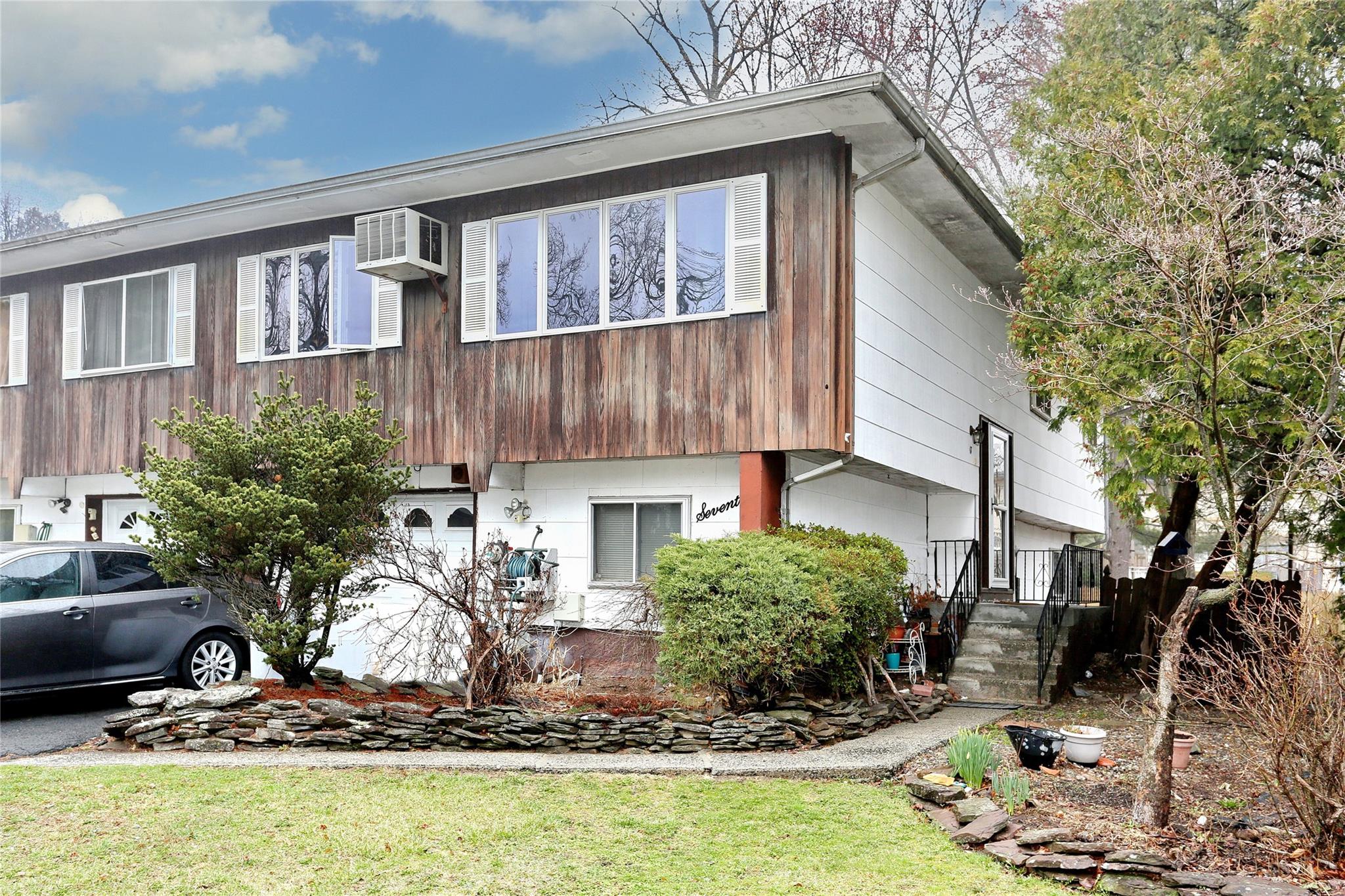 a front view of a house with garden
