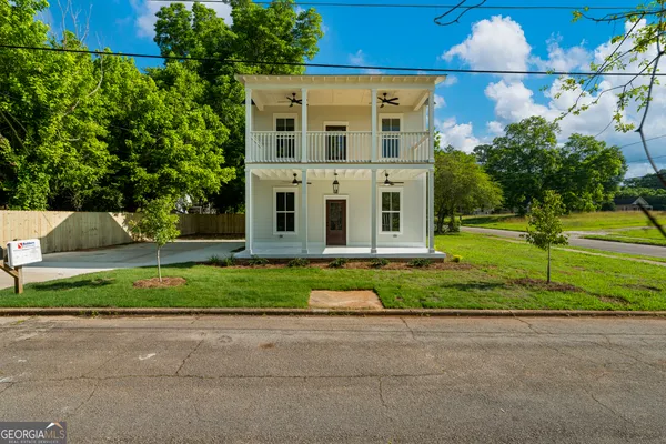 a front view of house with yard and green space