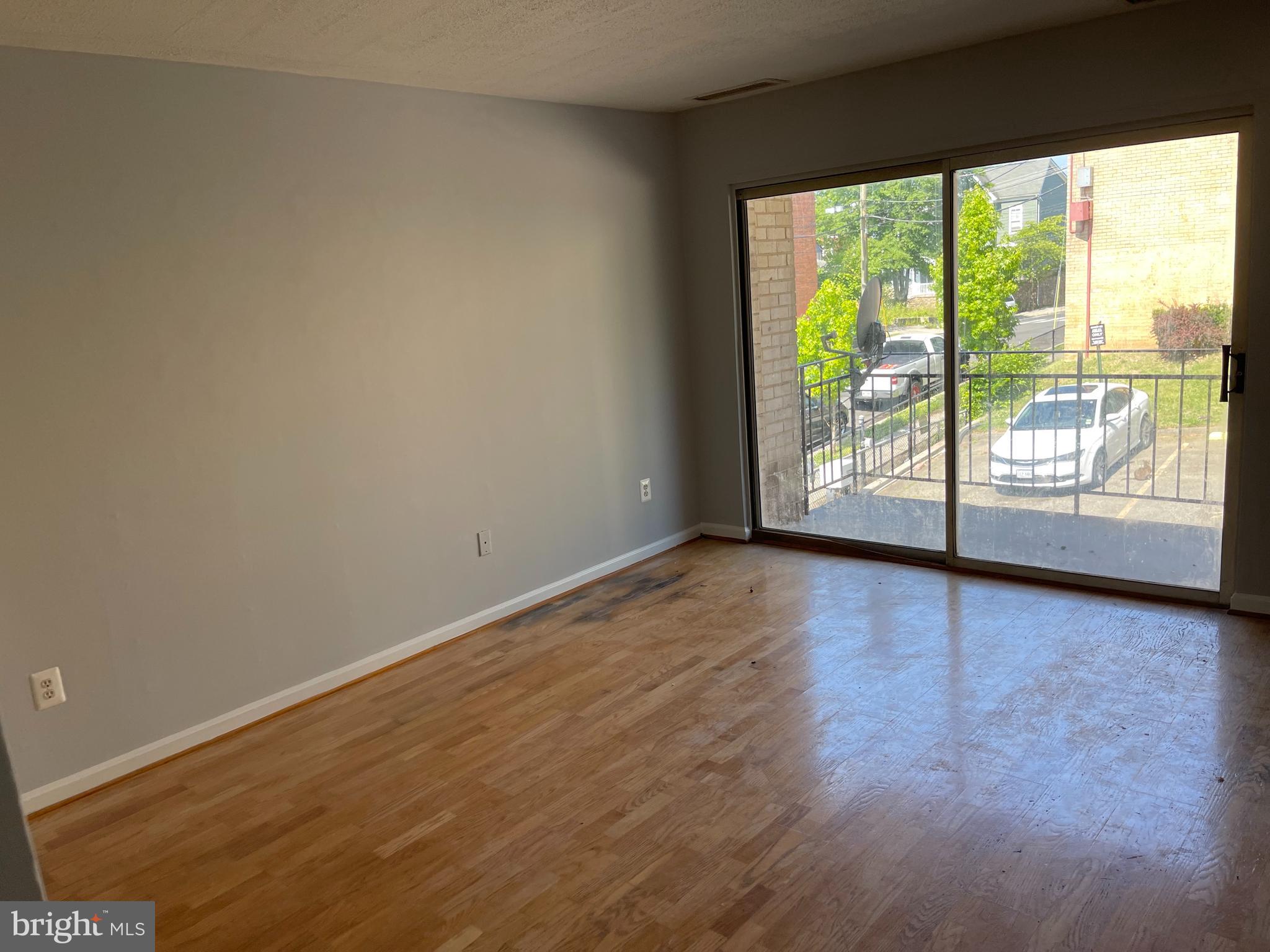 5106 F Street Southeast, Unit 8 Washington, DC 20019 - Photo 12 of 39 a view of an empty room with wooden floor and a window