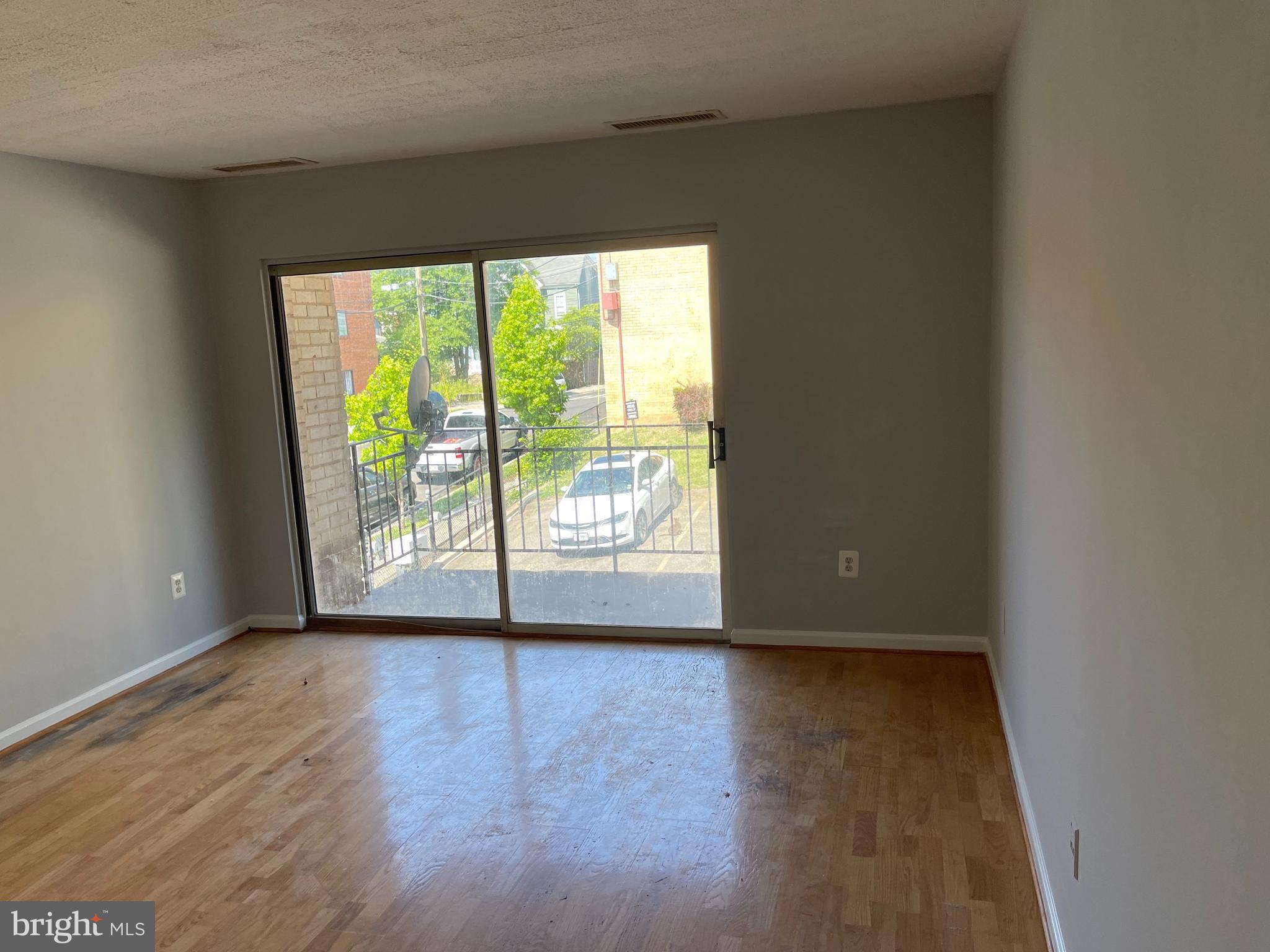 5106 F Street Southeast, Unit 8 Washington, DC 20019 - Photo 9 of 39 a view of an empty room with wooden floor and a window
