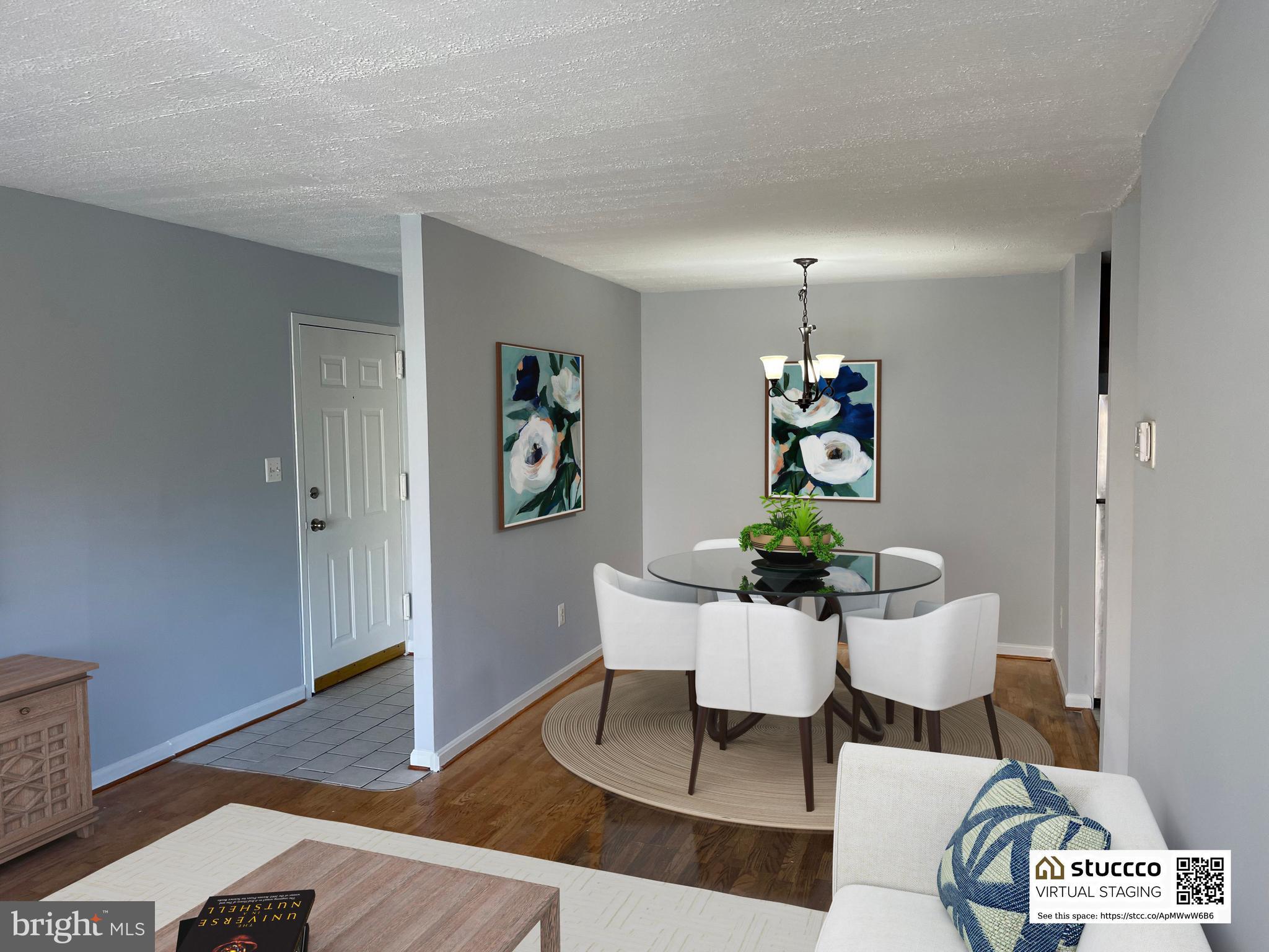 5106 F Street Southeast, Unit 8 Washington, DC 20019 - Photo 10 of 39 a view of a dining room with furniture wooden floor and a chandelier