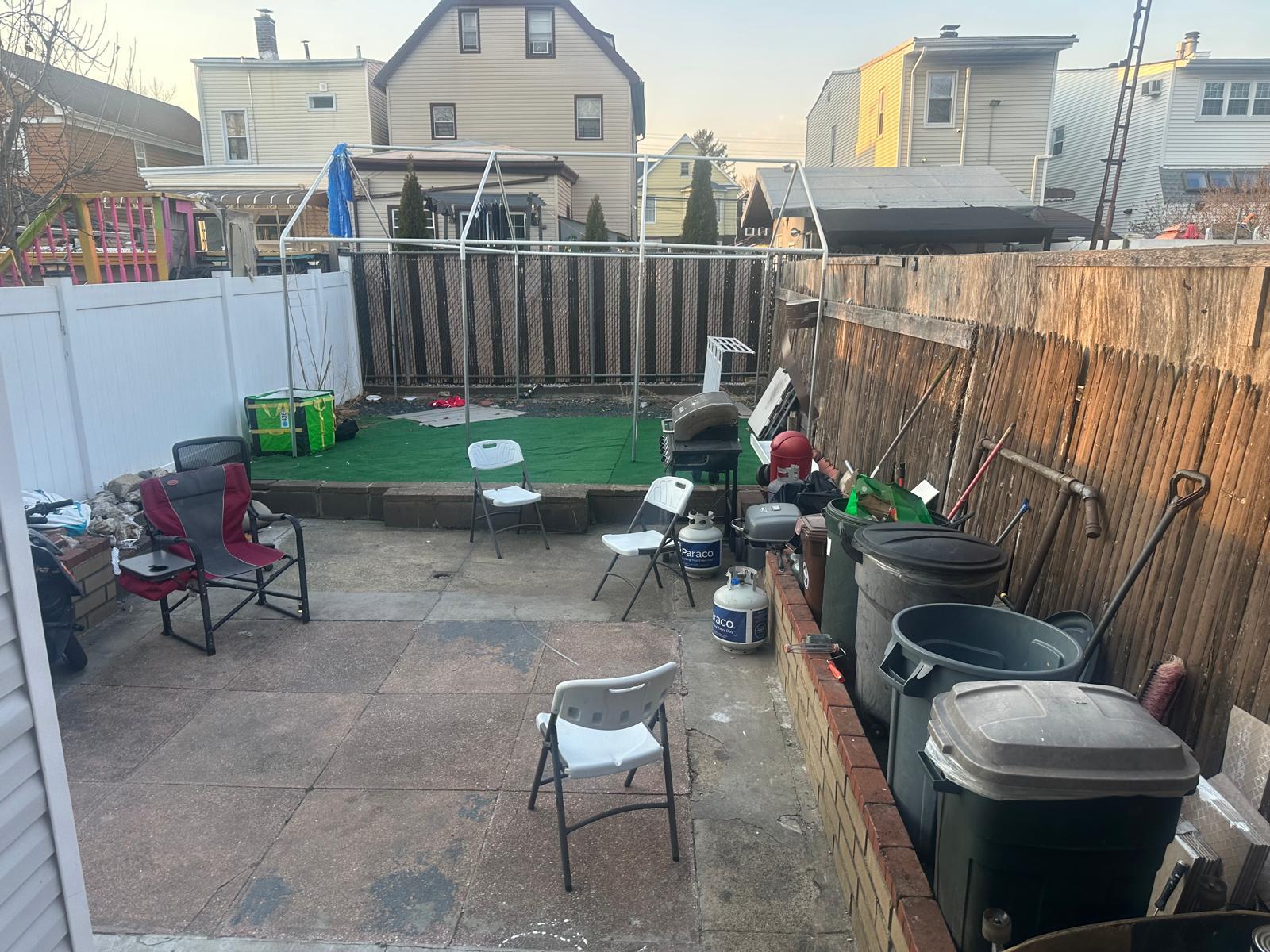 81-11 91st Avenue Queens, NY 11421 - Photo 15 of 15 a view of a chairs and table in the back yard of the house