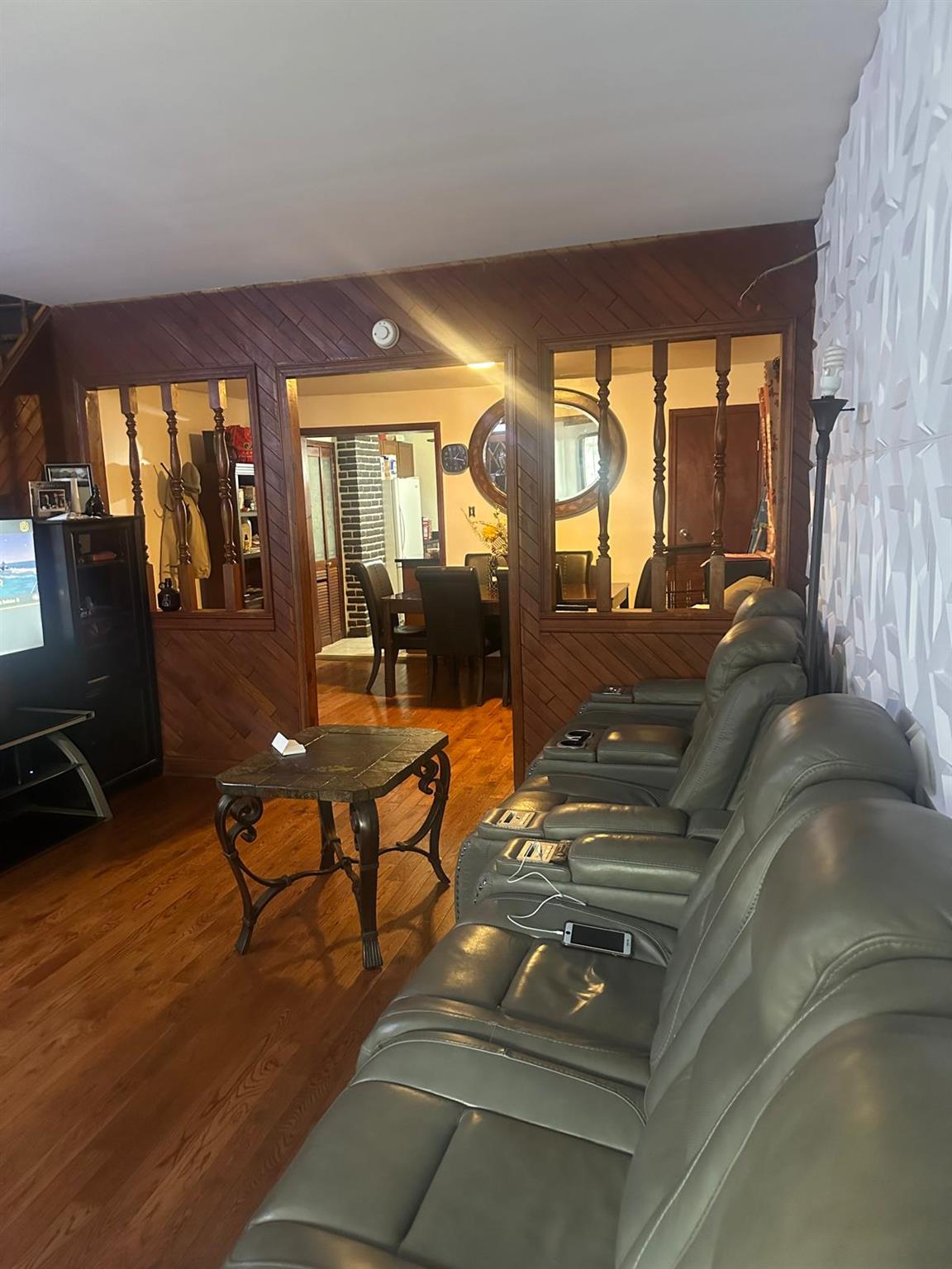 81-11 91st Avenue Queens, NY 11421 - Photo 5 of 15 a living room with furniture and a floor to ceiling window