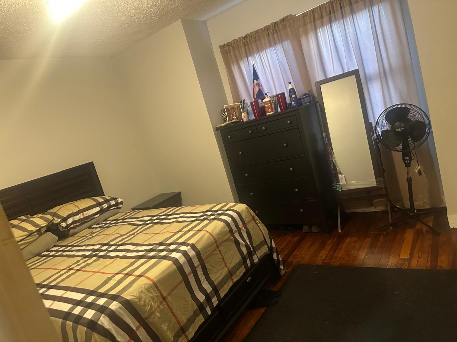 81-11 91st Avenue Queens, NY 11421 - Photo 9 of 15 a bedroom with a bed and a mirror