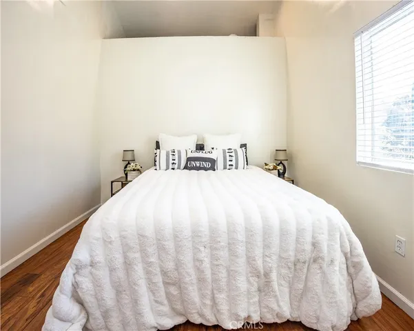 a large bed sitting in a bedroom next to a window