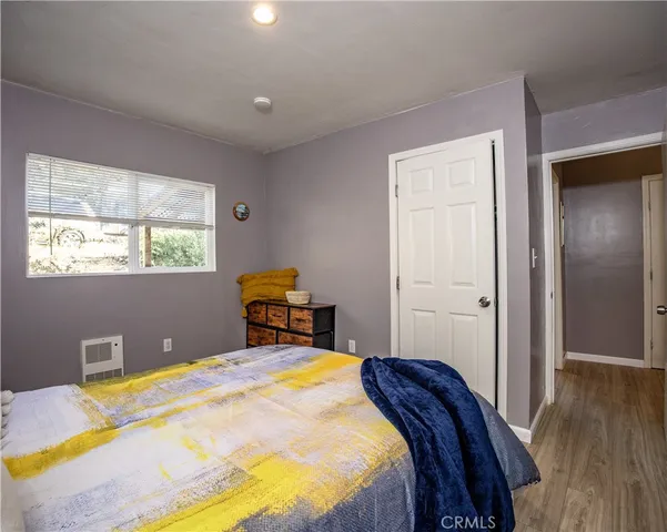 a bed sitting in a bedroom next to a window