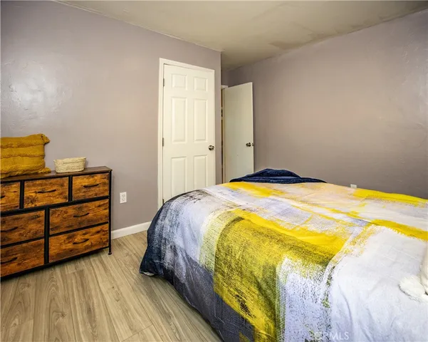 a bedroom with a bed and cabinet