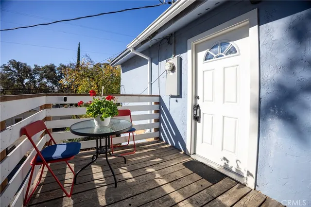a view of a balcony with chairs and a potted plant