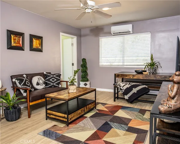 a living room with furniture a chandelier and a window