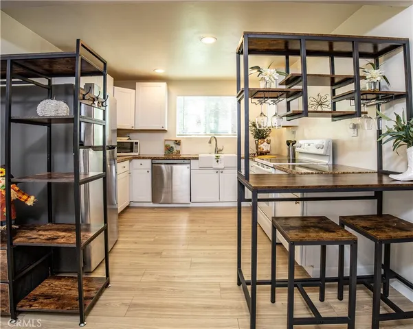 a kitchen with stainless steel appliances granite countertop a stove top oven and cabinets