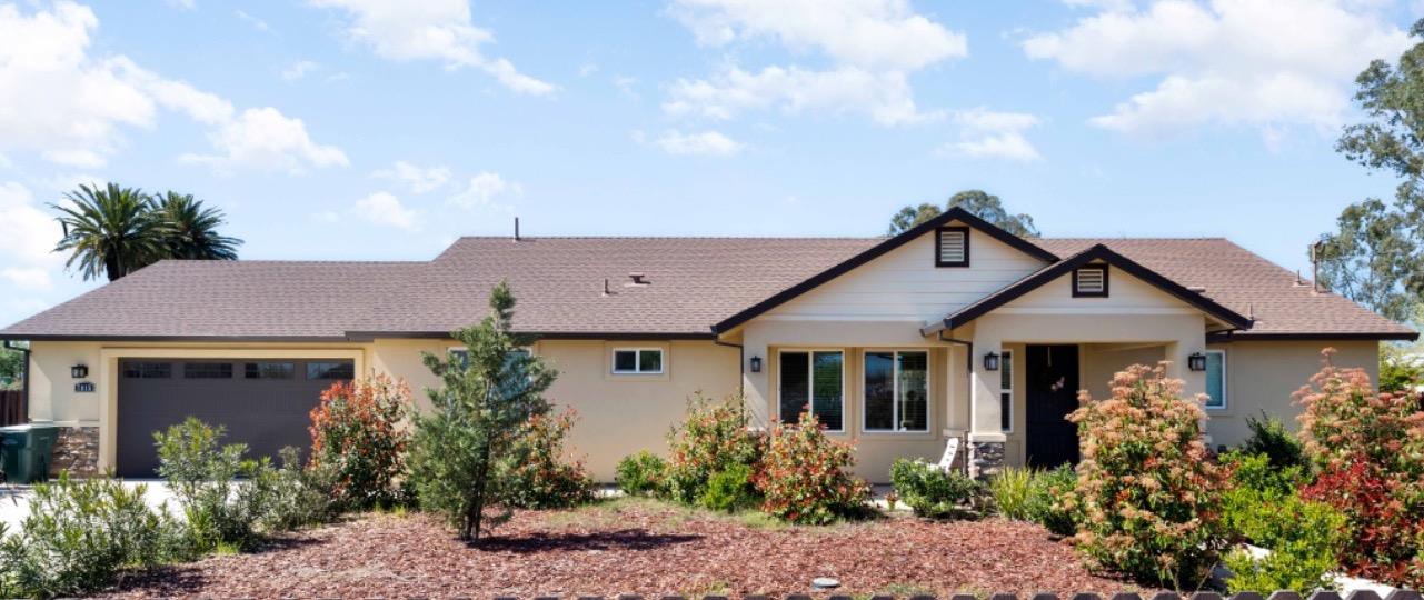 a front view of a house with garden
