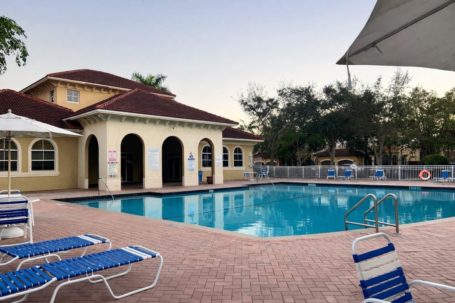 4903 Southwest 140th Terrace Miramar, FL 33027 - Photo 17 of 19 a view of a house with pool porch and chairs
