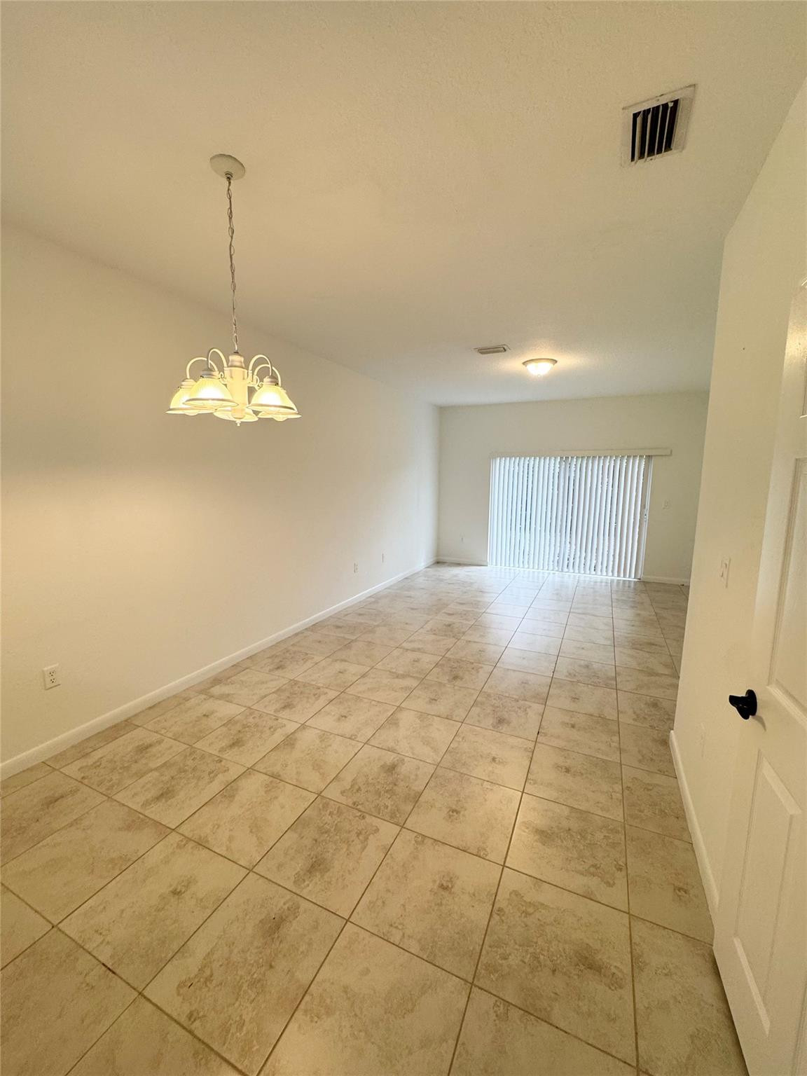 4903 Southwest 140th Terrace Miramar, FL 33027 - Photo 5 of 19 a view of an empty room with a window