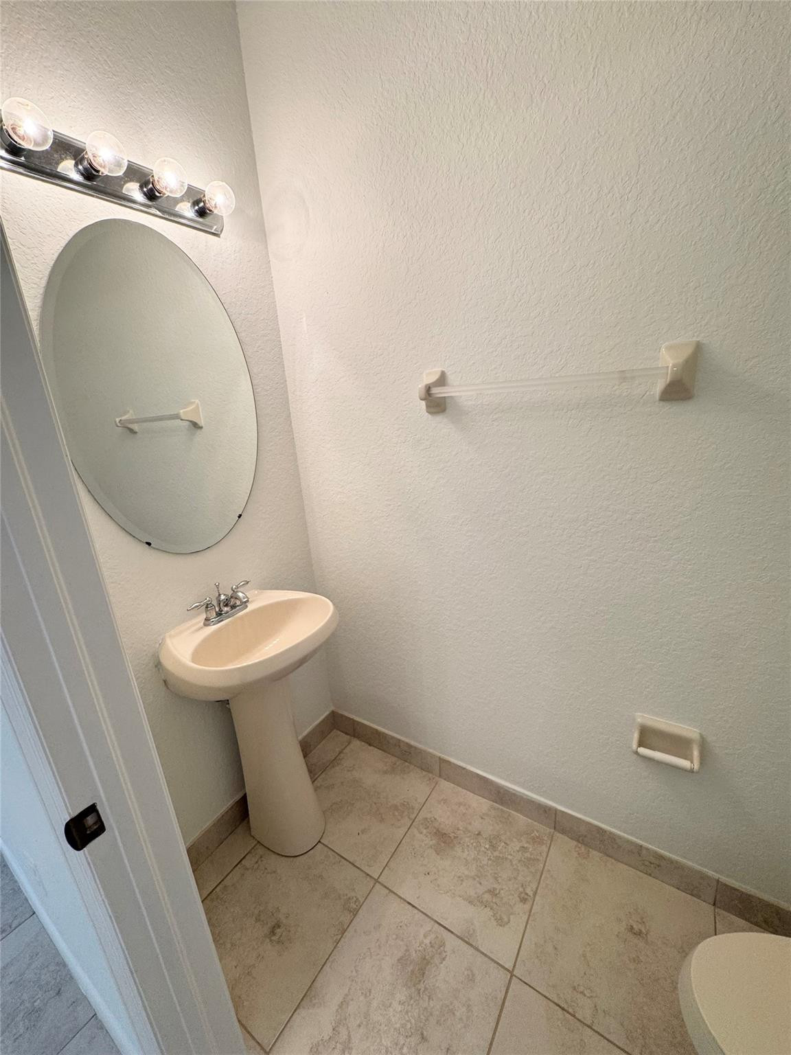 4903 Southwest 140th Terrace Miramar, FL 33027 - Photo 8 of 19 a bathroom with a sink a toilet and a mirror