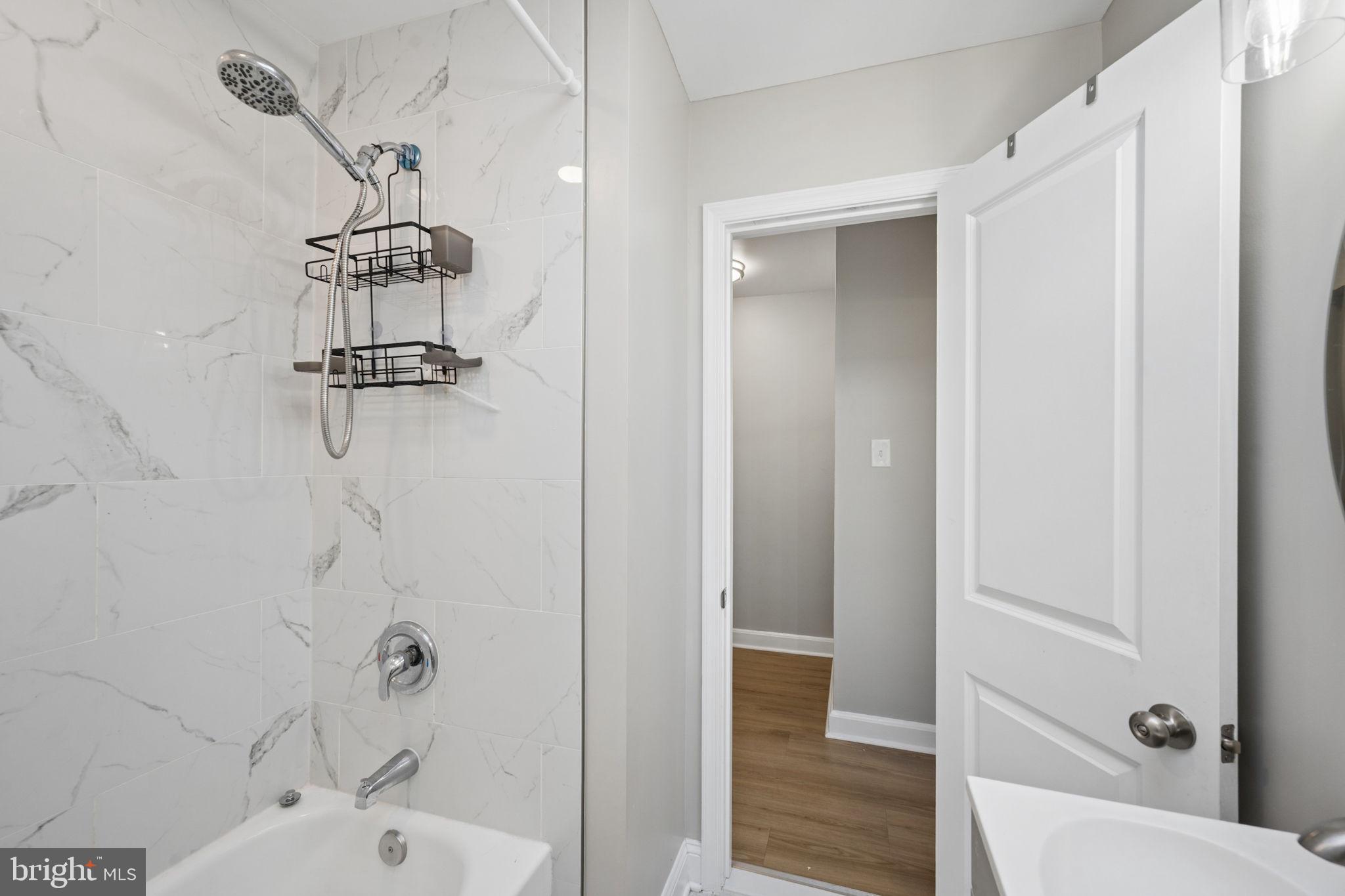 3548 Benzinger Road Baltimore, MD 21229 - Photo 20 of 40 a bathroom with a bathtub and shower