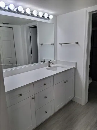 a bathroom with a double vanity sink and mirror
