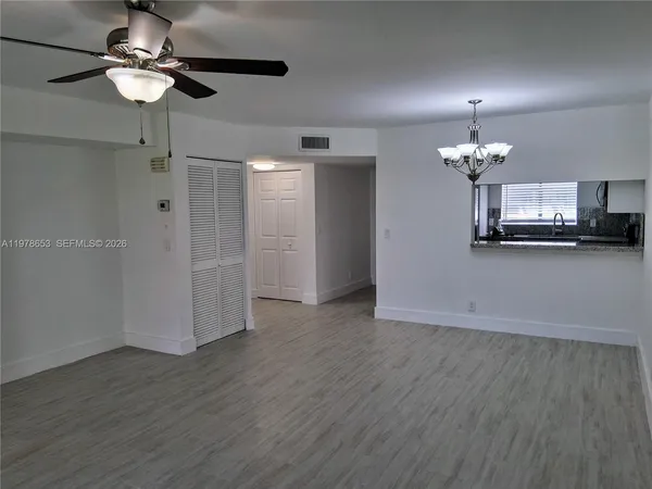 a view of a livingroom with a chandelier fan