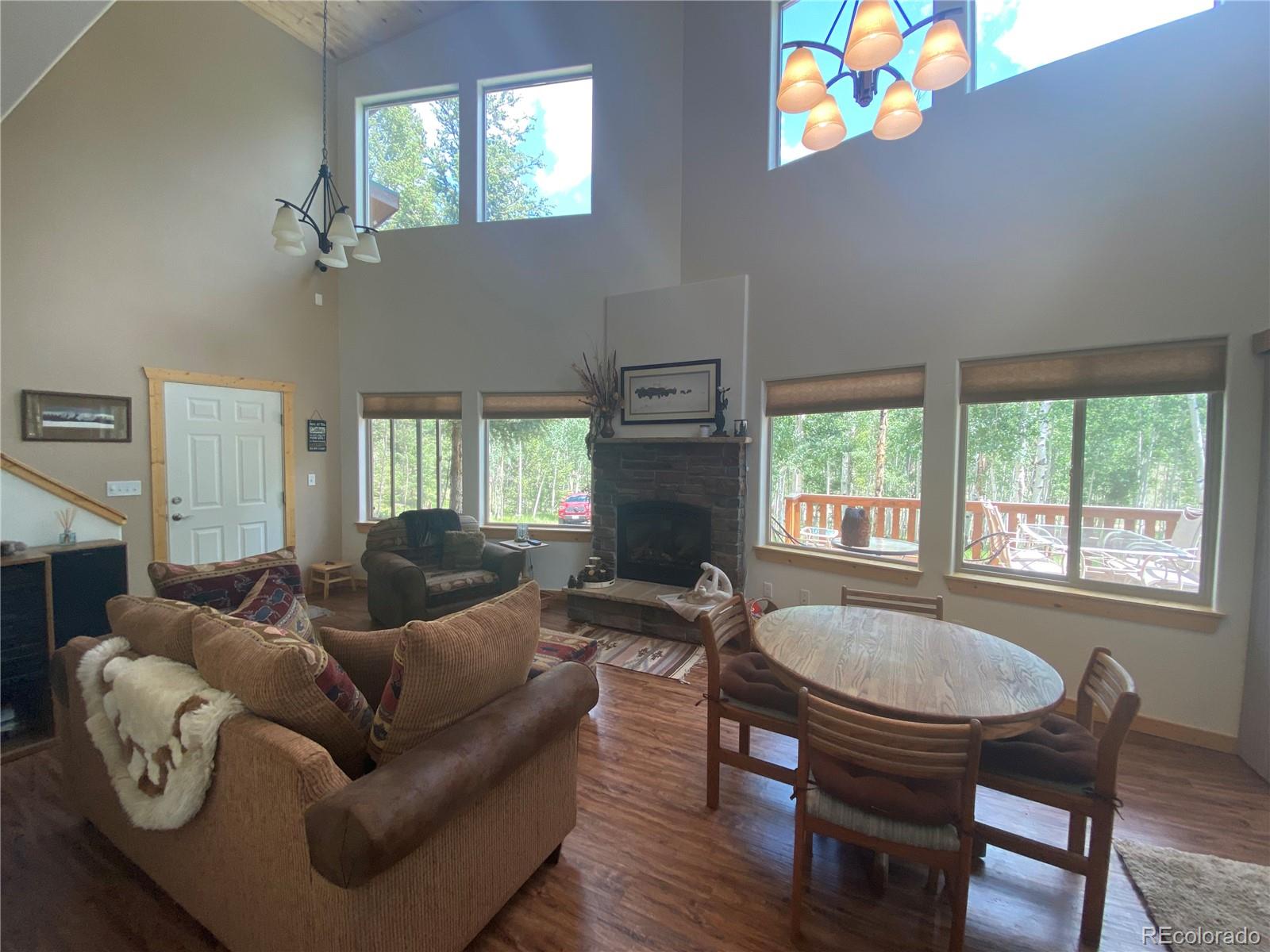 538 Campfire Road Hartsel, CO 80449 - Photo 8 of 40 a living room with furniture a fireplace and a table