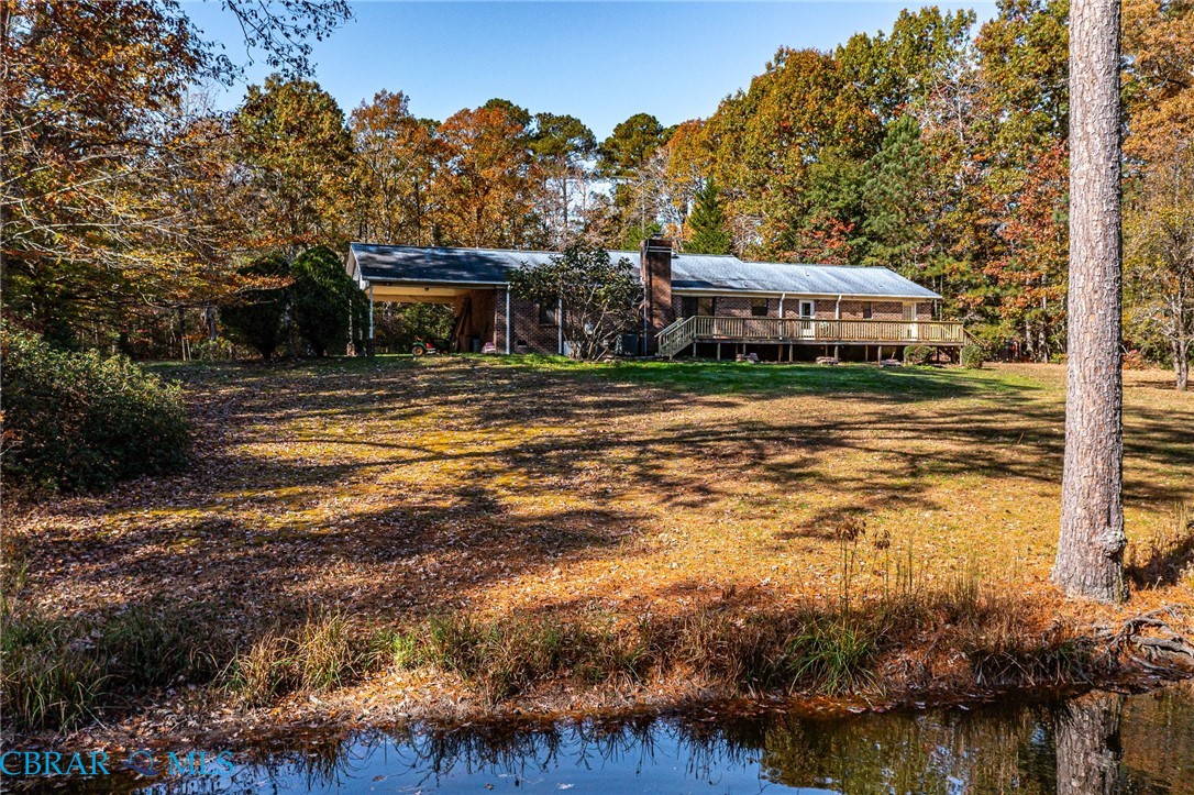278 Regent Road Hartfield, VA 23071 - Photo 33 of 49 Rear view of house with a water view and a lawn