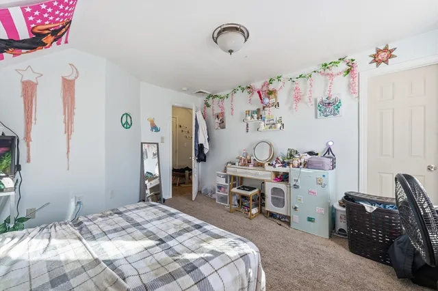 a bedroom with a bed and a desk