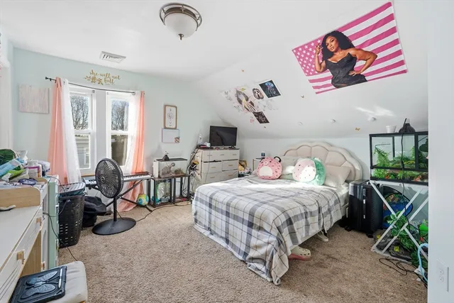 a bedroom with bed and a large window