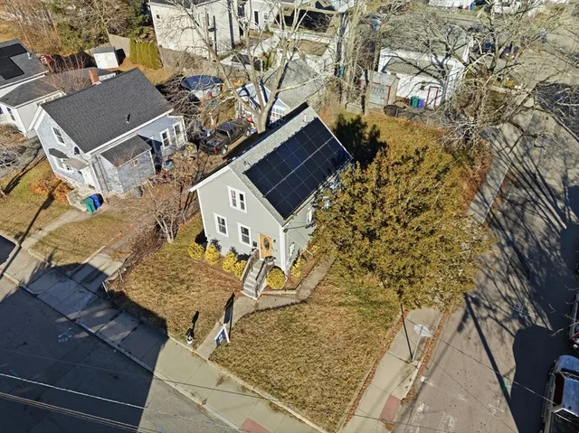 an aerial view of a house with a yard