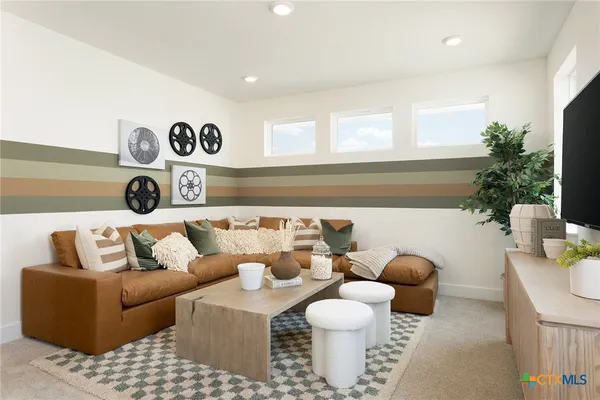 a living room with furniture and a potted plant