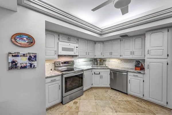 a kitchen with stainless steel appliances granite countertop a stove and a sink