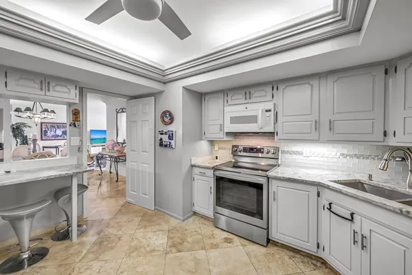 a kitchen with stainless steel appliances granite countertop a stove cabinets and entryway