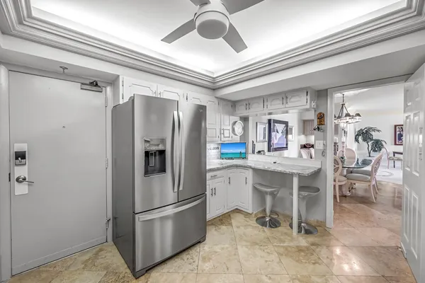 a kitchen with stainless steel appliances granite countertop a refrigerator and a sink