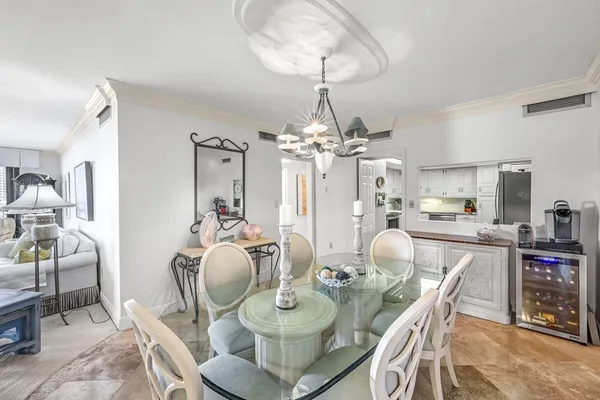 a view of a dining room with furniture a chandelier and wooden floor