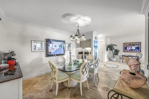 a view of a dining room with furniture and chandelier