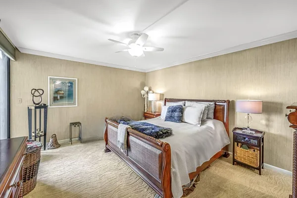 a bedroom with a bed and lamp on dresser