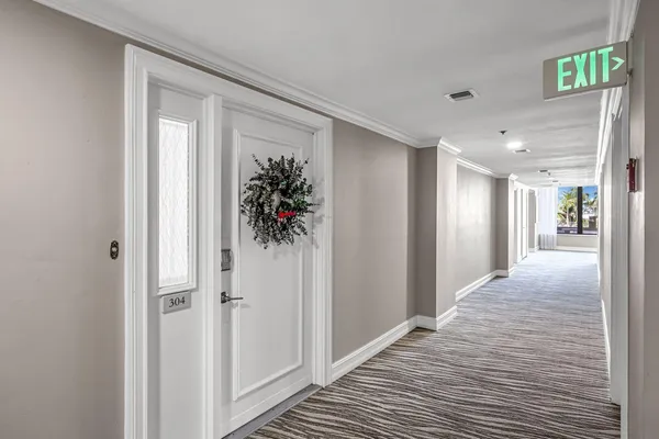 a view of a hallway to closet with wooden floor