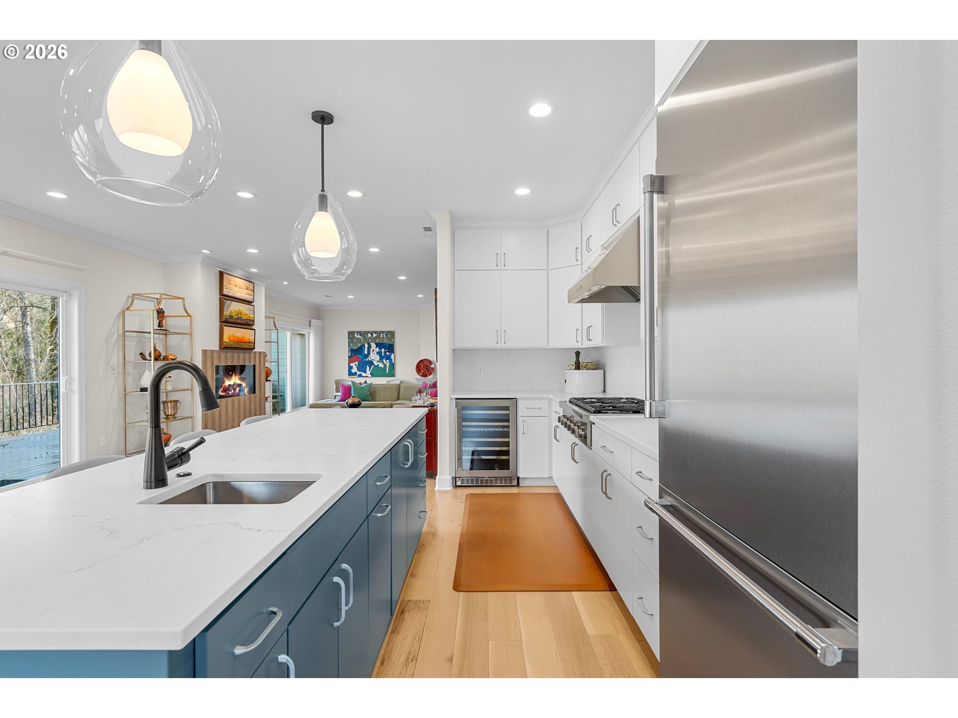 1716 Northwest Mill Pond Road Portland, OR 97229 - Photo 12 of 48 a kitchen with kitchen island white cabinets and stainless steel appliances