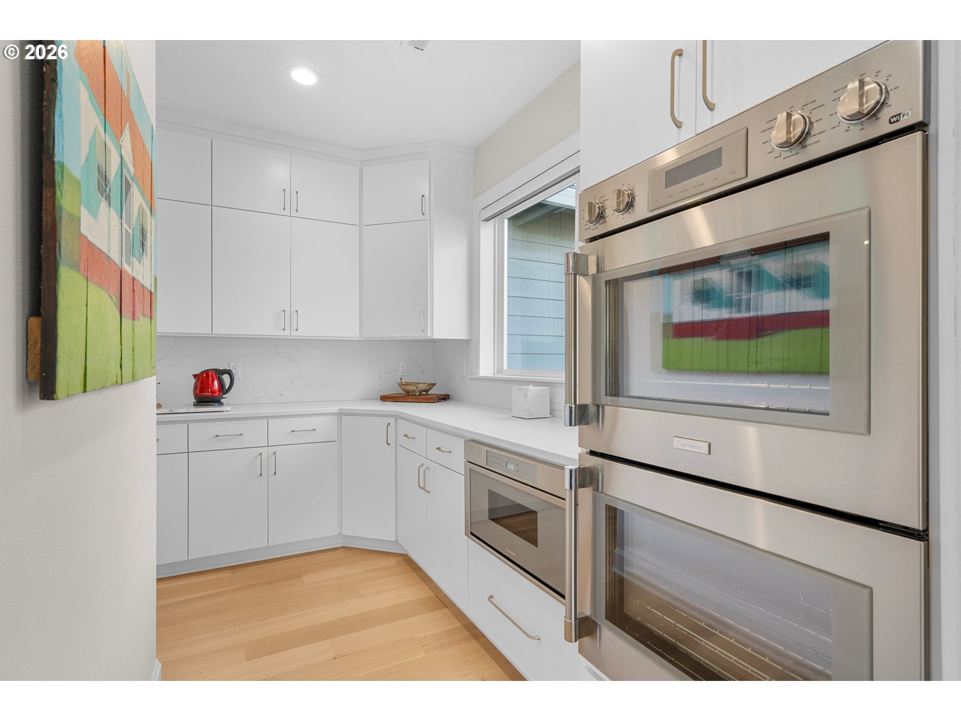 1716 Northwest Mill Pond Road Portland, OR 97229 - Photo 15 of 48 a kitchen with stainless steel appliances white cabinets and a window