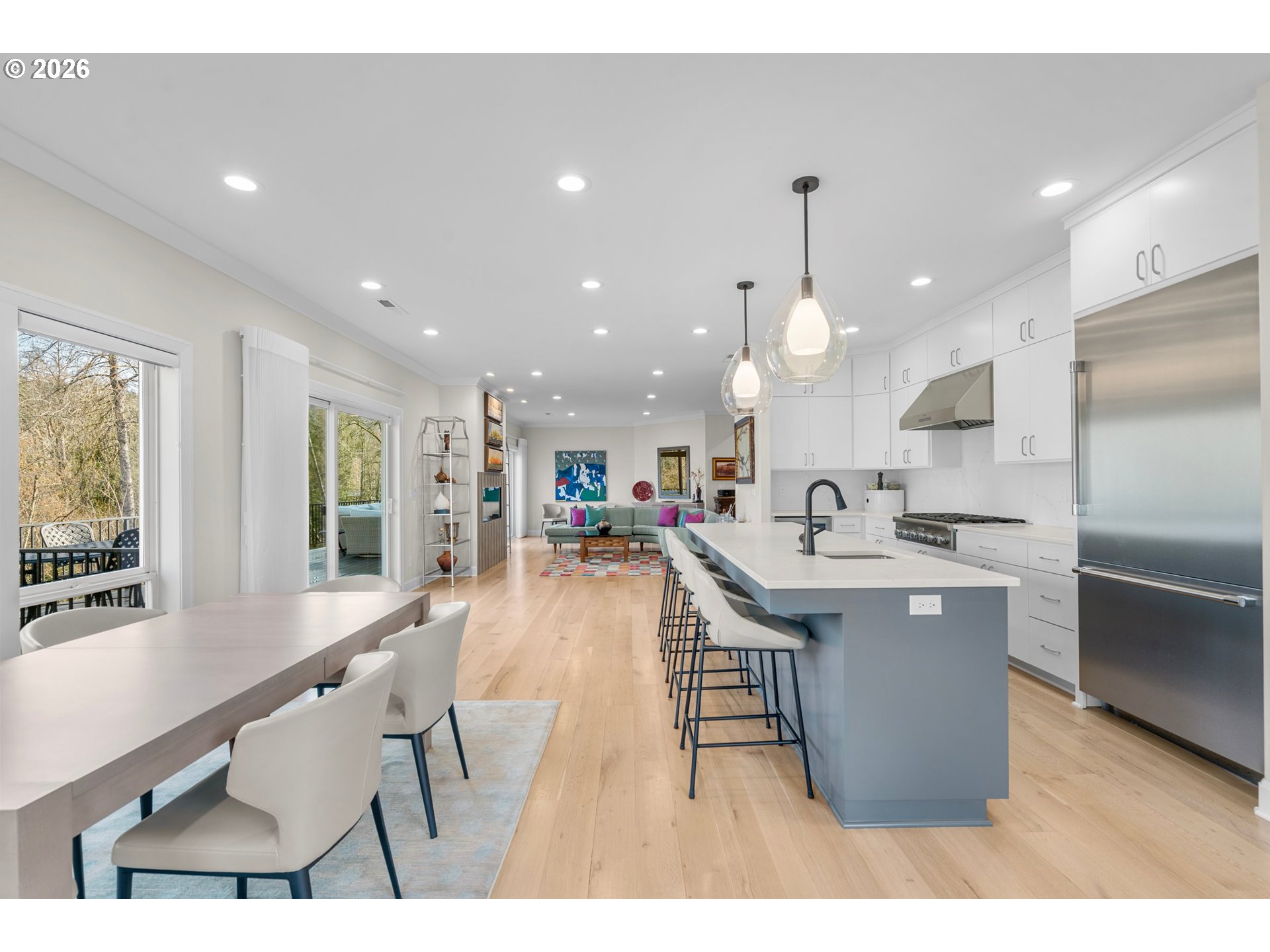 1716 Northwest Mill Pond Road Portland, OR 97229 - Photo 17 of 48 a dining hall with stainless steel appliances kitchen island granite countertop a table chairs and a refrigerator