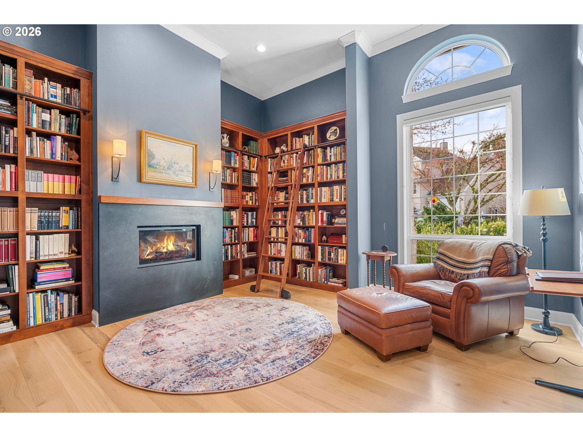 1716 Northwest Mill Pond Road Portland, OR 97229 - Photo 21 of 48 a living room with fireplace furniture and a book shelf