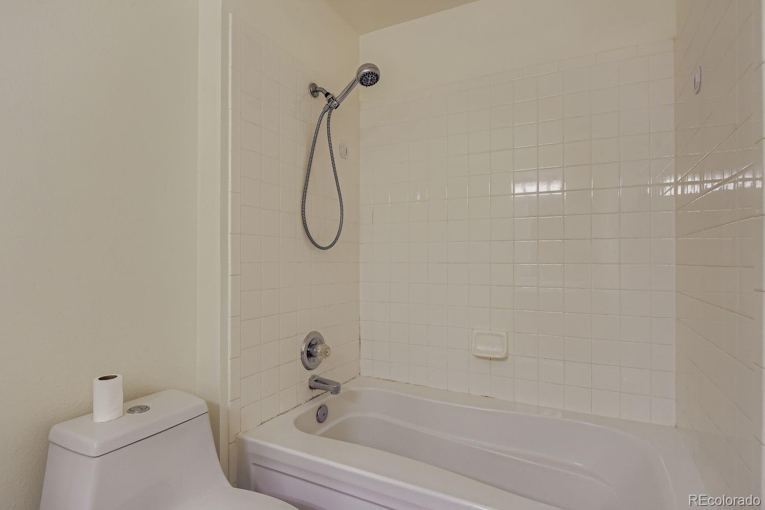 3261 South Waco Court, Unit B Aurora, CO 80013 - Photo 12 of 21 a bathroom with a bathtub and shower