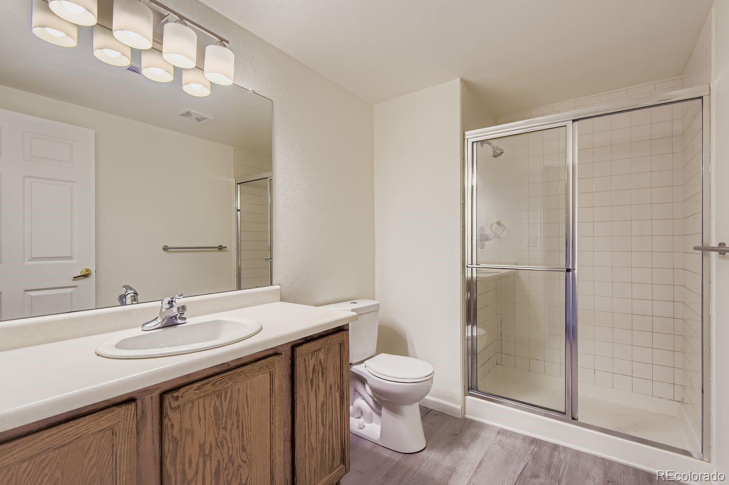 3261 South Waco Court, Unit B Aurora, CO 80013 - Photo 15 of 21 a bathroom with a sink toilet and shower