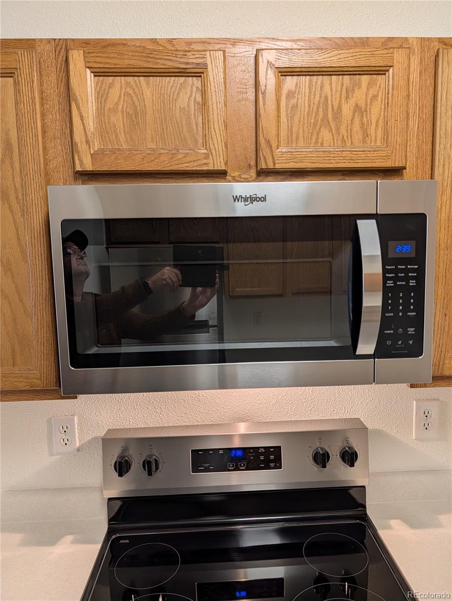 3261 South Waco Court, Unit B Aurora, CO 80013 - Photo 18 of 21 a stove top oven sitting inside of a kitchen