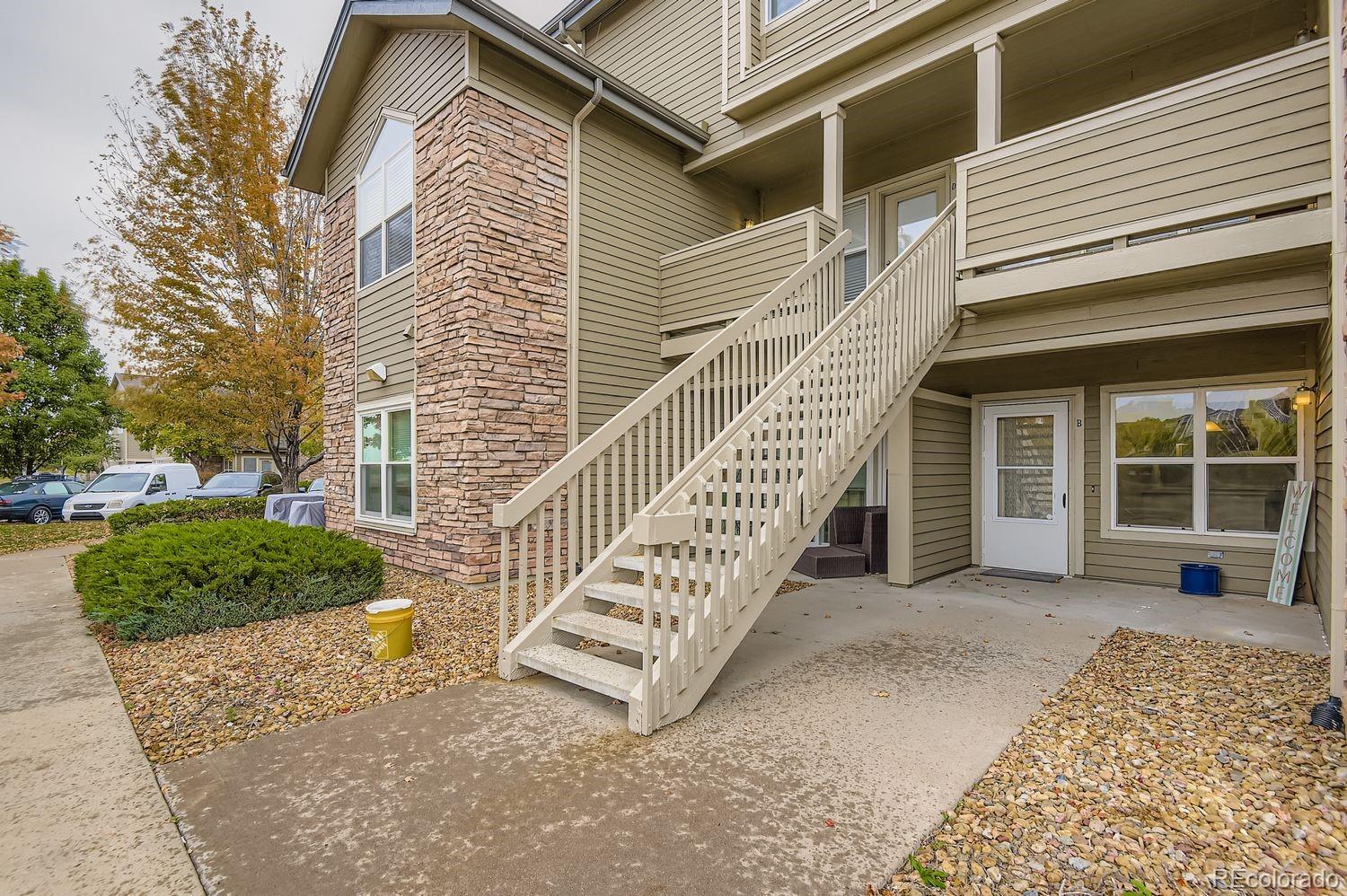 3261 South Waco Court, Unit B Aurora, CO 80013 - Photo 2 of 21 a view of a house with a yard