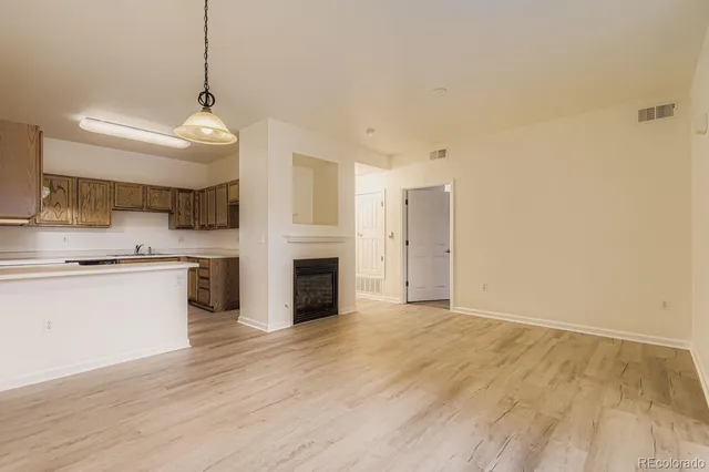 a view of a kitchen with a sink and a stove top oven